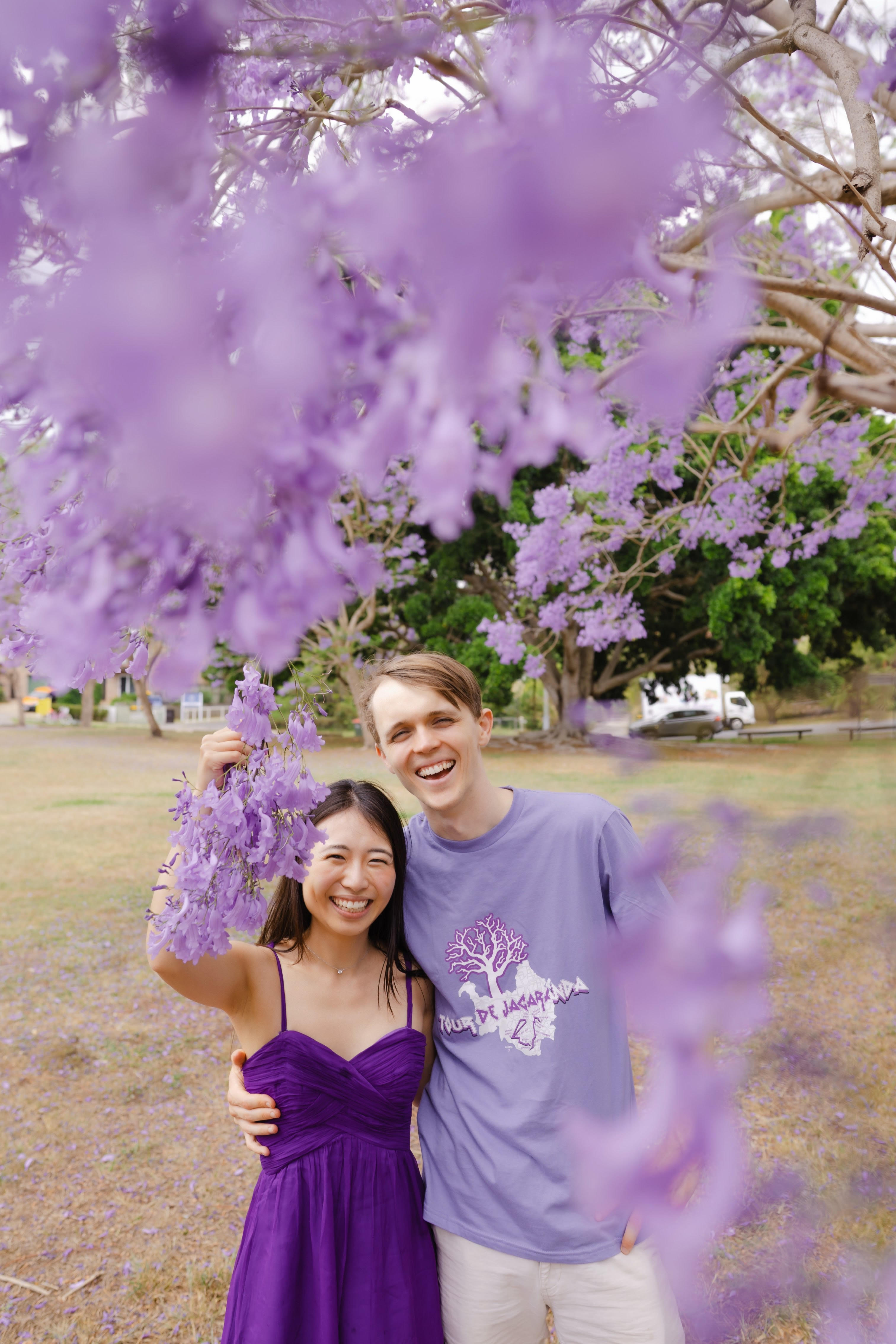 Andrew and Shiori under jacaranda blossoms